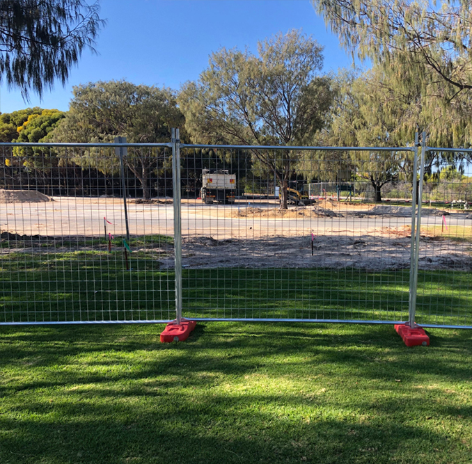 temporary fencing on grass at construction site